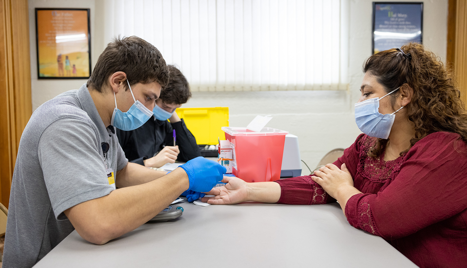 Student pricks patient's finger in clinic 