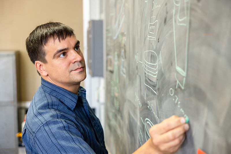 Spencer Kuhl, director of operations, reviews sketches at the Van Allen Hall location of Protostudios.