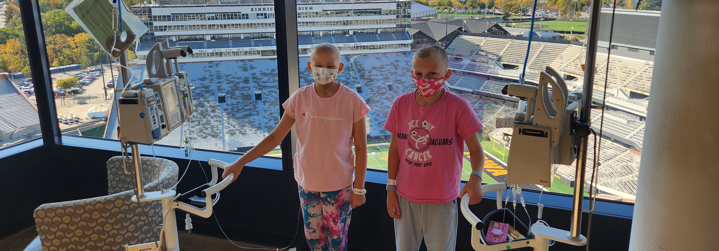 Bella and Harper standing near window at University of Iowa Stead Family Children's Hospital