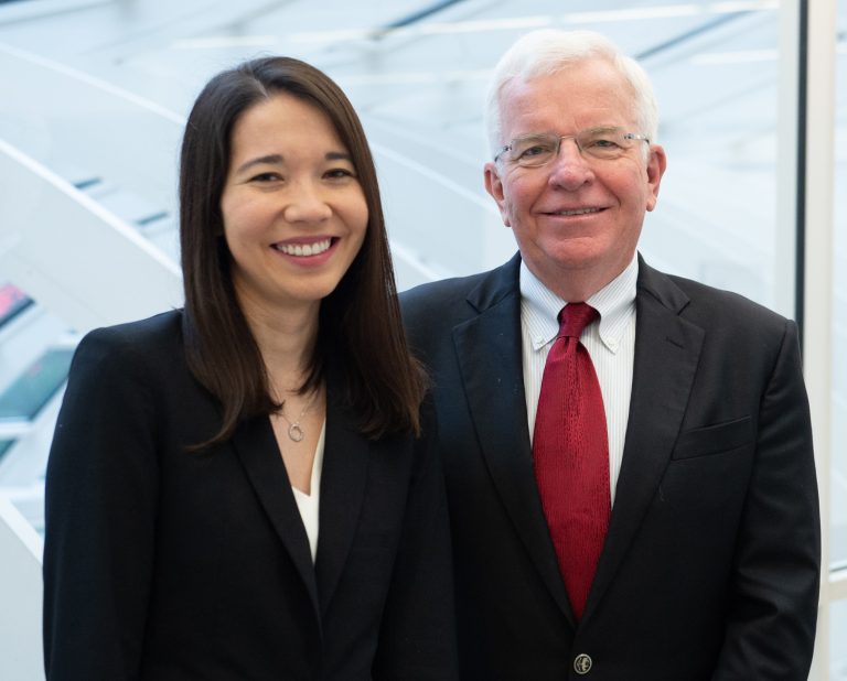 father and daughter both wearing black suits