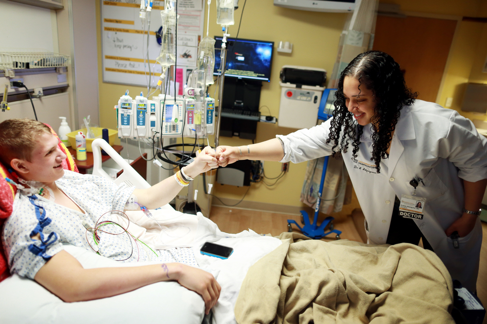 Doctor and patient fist-bumping