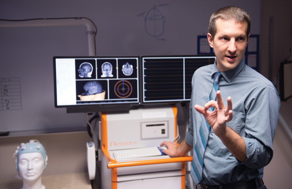 neurologist and an image of a brain scan