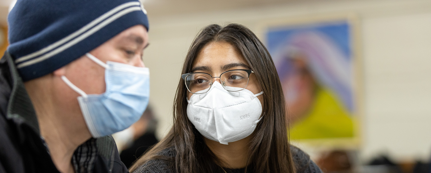 A Mobile Clinic coordinator helps a patient during a visit. 