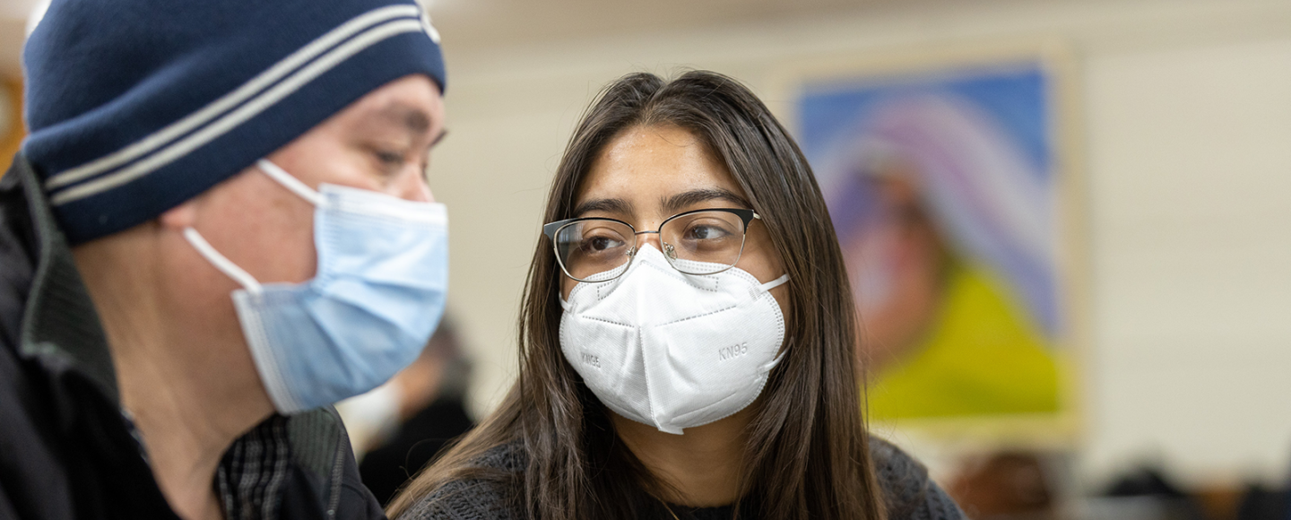 A Mobile Clinic coordinator helps a patient during a visit.