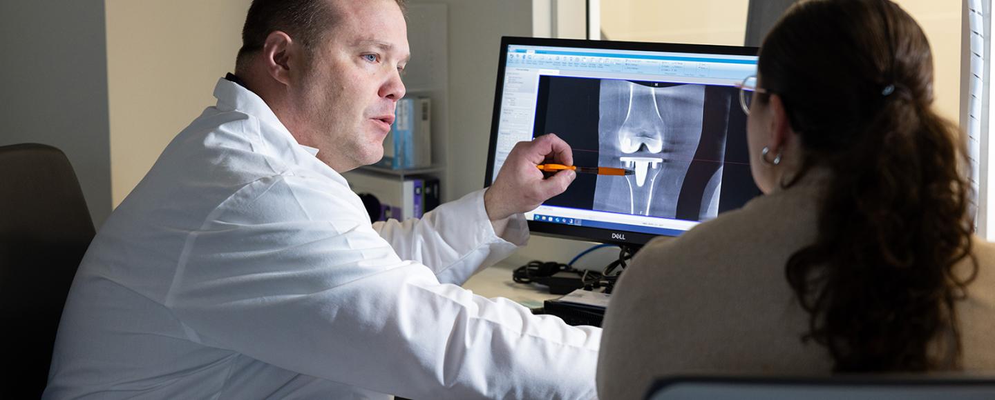 Dr.-Jacob-Elkins-showing-image-to-patient