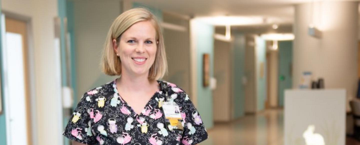 nurse standing in hospital hallway