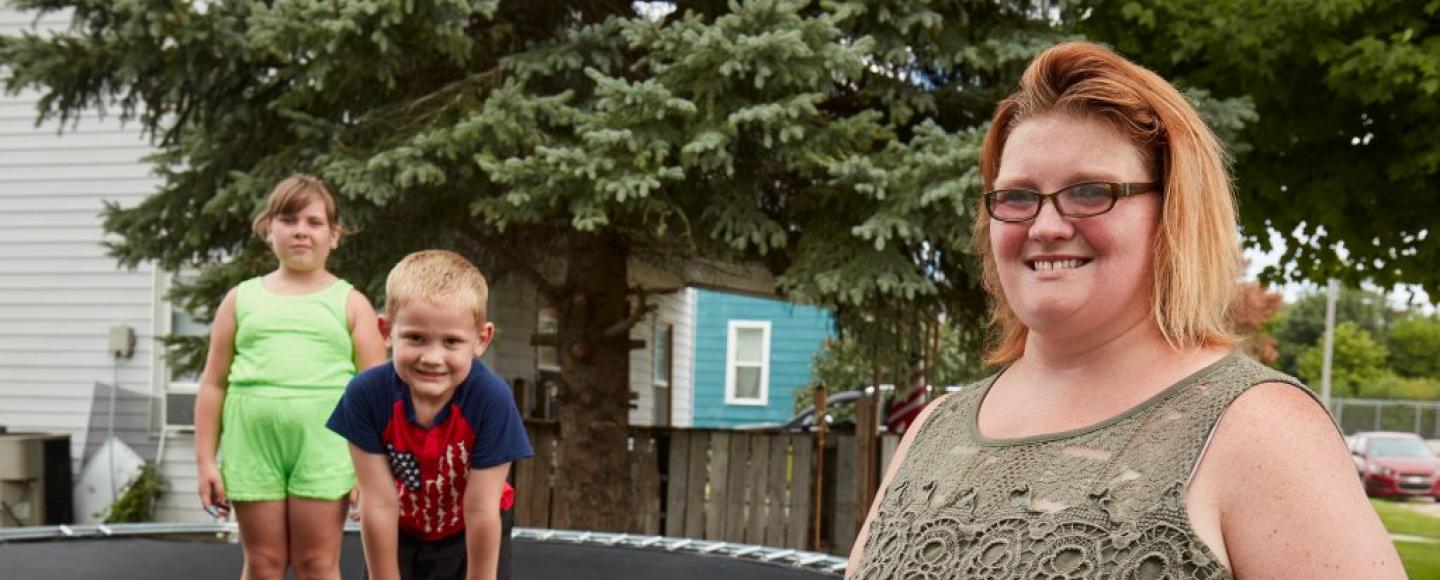 a woman with her kids on a trampoline