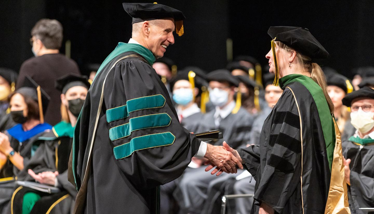 Brooks Jackson congratulates new graduate