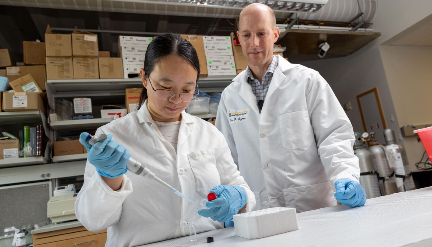 James Byrne and Jianling conducting an experiment in a lab