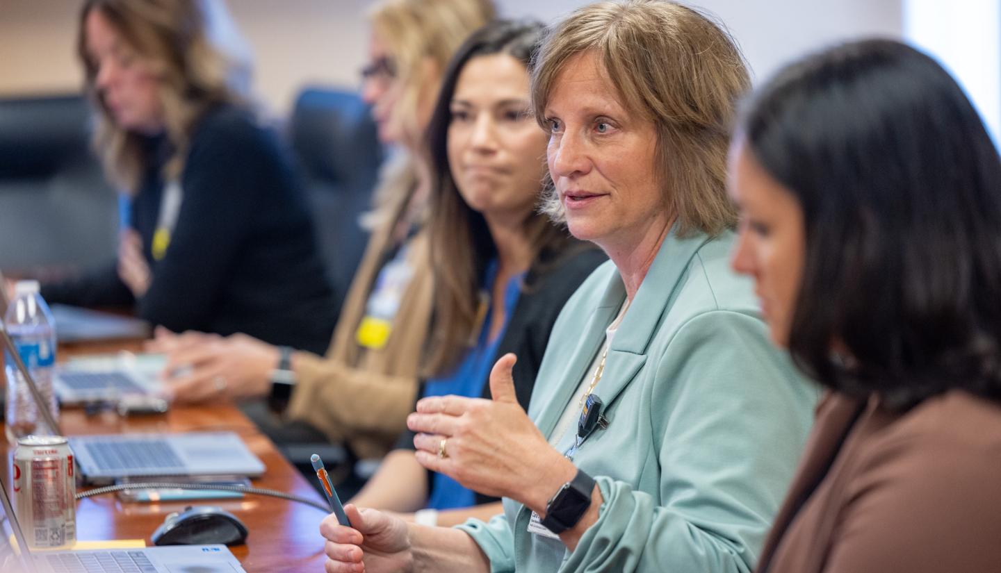 Carol Doser, client relations manager for Community Connect Iowa at UI Health Care, confers with the team at Iowa Specialty Hospitals & Clinics in Belmond, Iowa.