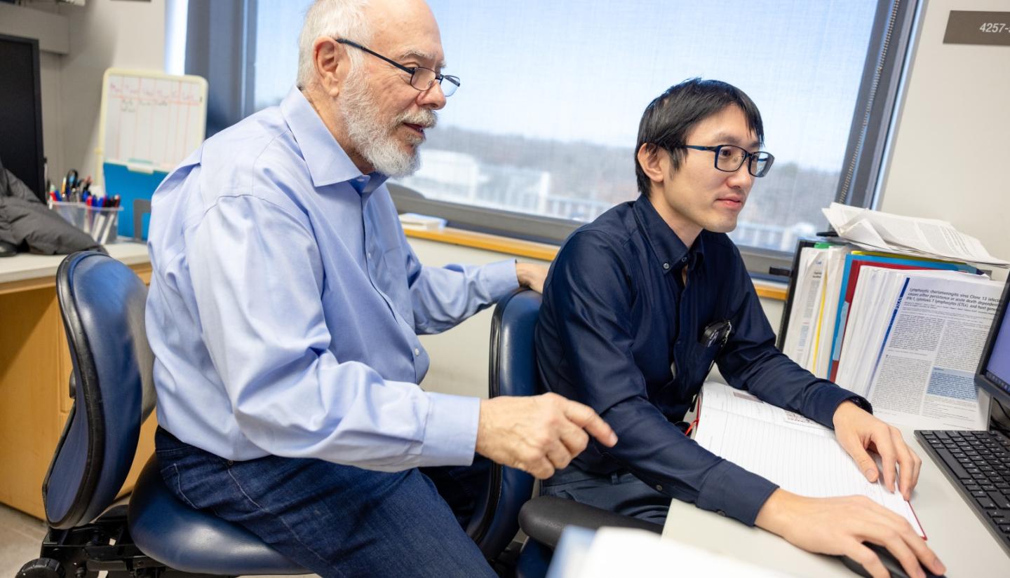 Kevin Campbell with student at desk