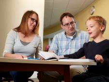 two parents and child reading