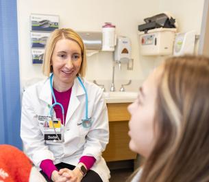 Dr. Lyndsay Harshman with a pediatric kidney transplant patient in the Pediatric Specialty Clinic on Tuesday, Jan. 16, 2024. 