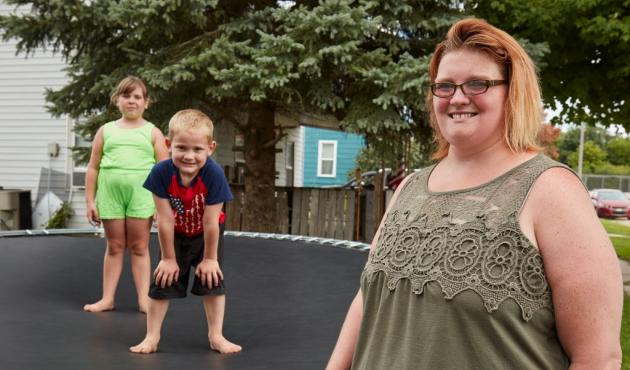a woman with her kids on a trampoline