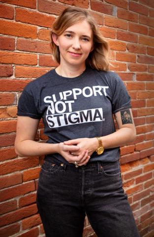 Sarah Ziegenhorn standing in front of a brick wall