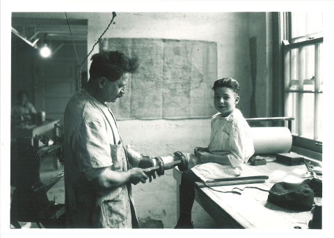 P.G. Mott constructs a brace for a child in the Children's Hospital brace shop, May 1920